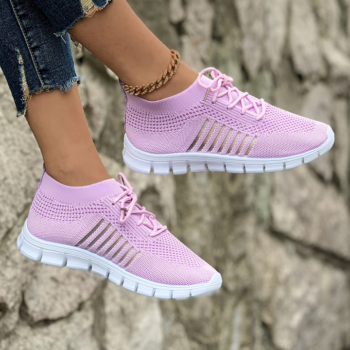 A woman wearing light breathable sock-style comfort shoes