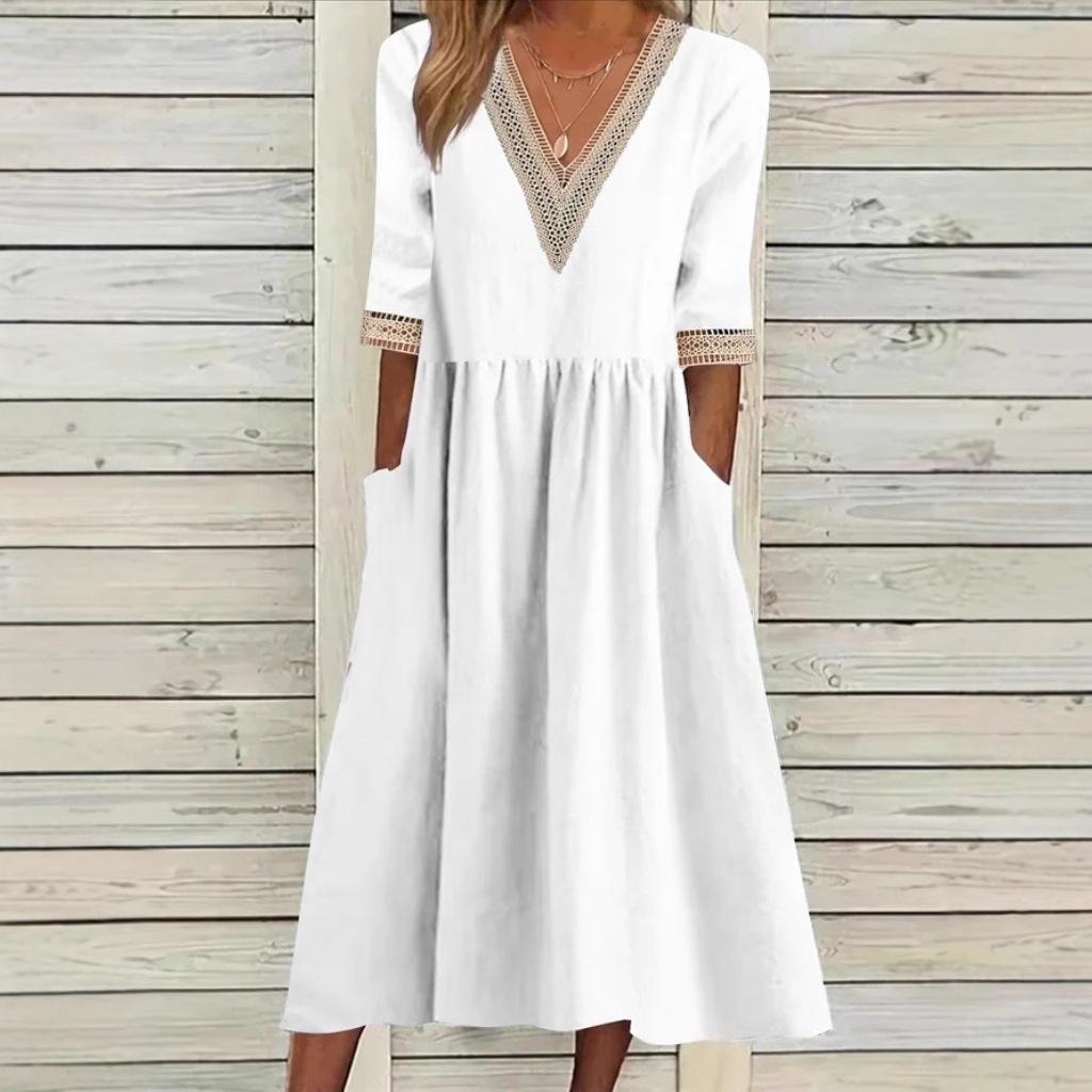 A woman wearing the Anne V-neck midi dress with delicate detailing at the collar and sleeves.
