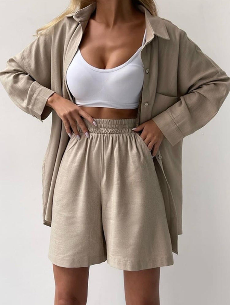 A woman wearing an oversized button-up shirt with matching high-waisted shorts.