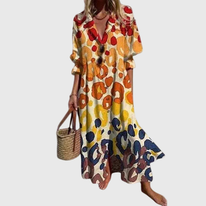 Woman in a long flowing boho-style maxi dress with delicate patterns, walking outdoors.