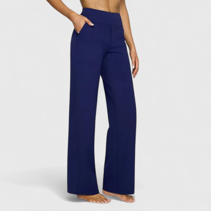 Woman wearing pull-on pants with a soft blouse, relaxed and comfortable at home.