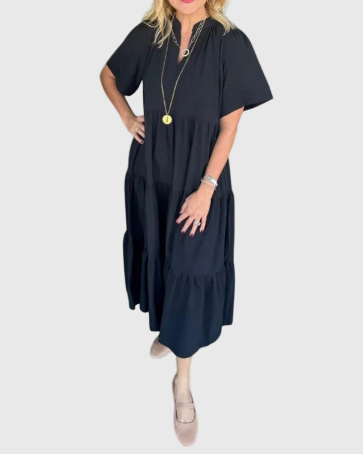 Woman wearing the Karen maxi dress with her hands resting in its side pockets.