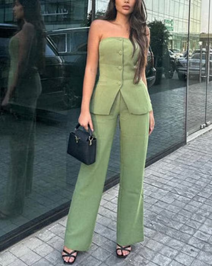 A woman wearing a tailored sleeveless button-detail top with matching wide-leg pants.