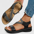 A woman wearing soft adjustable comfort sandals with a summer outfit, looking relaxed and content.