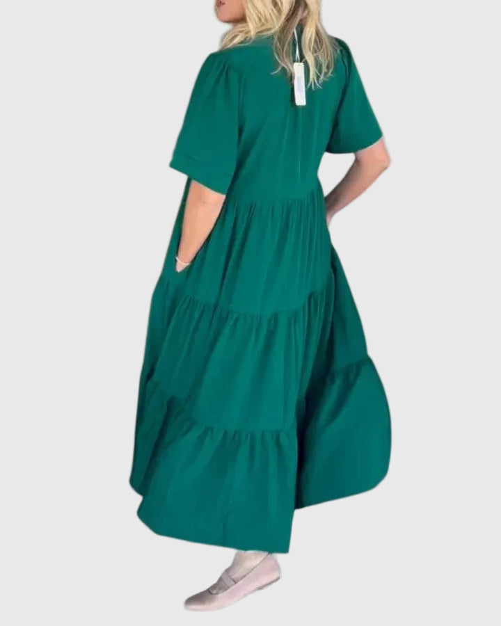 Woman wearing the Karen maxi dress with her hands resting in its side pockets.