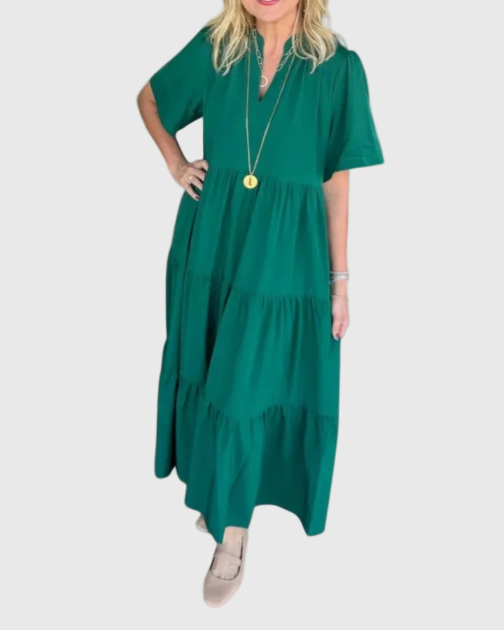 Woman wearing the Karen maxi dress with her hands resting in its side pockets.