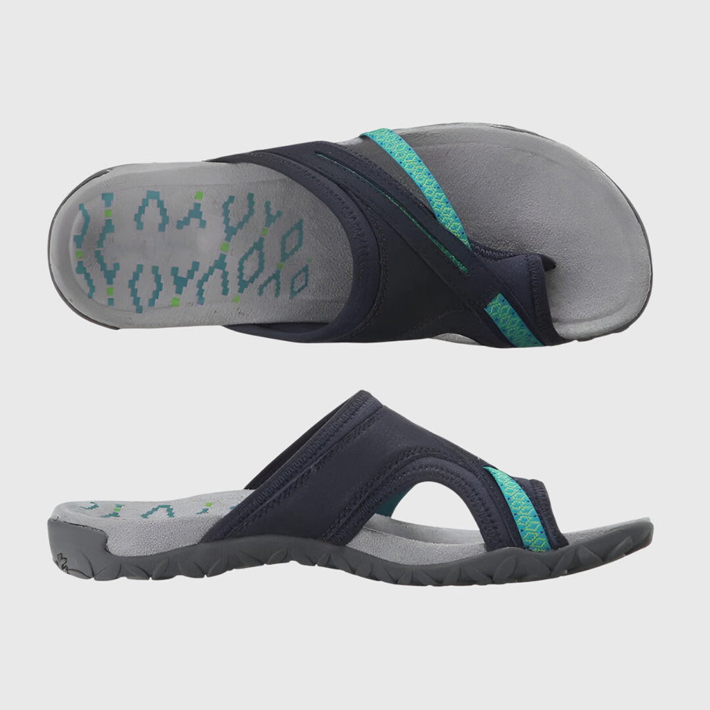 A woman wearing open-toe supportive sandals with a light summer outfit, walking comfortably and looking confident.