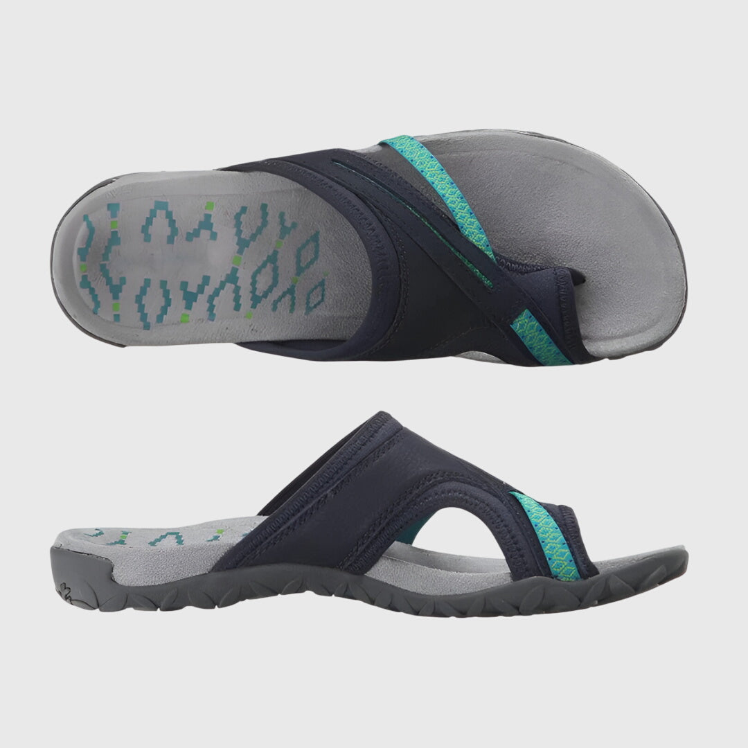 A woman wearing open-toe supportive sandals with a light summer outfit, walking comfortably and looking confident.