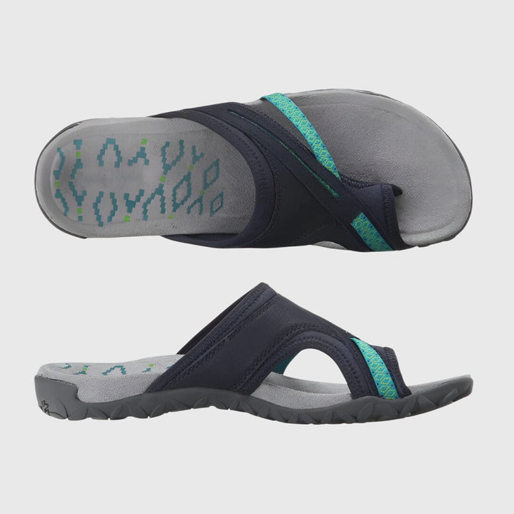 A woman wearing open-toe supportive sandals with a light summer outfit, walking comfortably and looking confident.