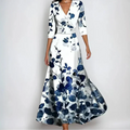 Woman wearing the Donna floral midi dress with wrap neckline and flowing skirt at a celebration.