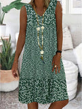 A woman wearing the Wendy sleeveless V-neck floral dress on a sunny day outdoors.
