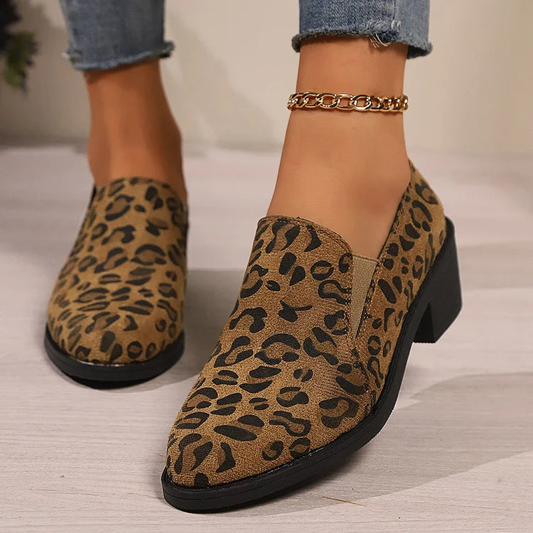 A woman wearing leopard-print loafers with jeans, stepping out with easy confidence.