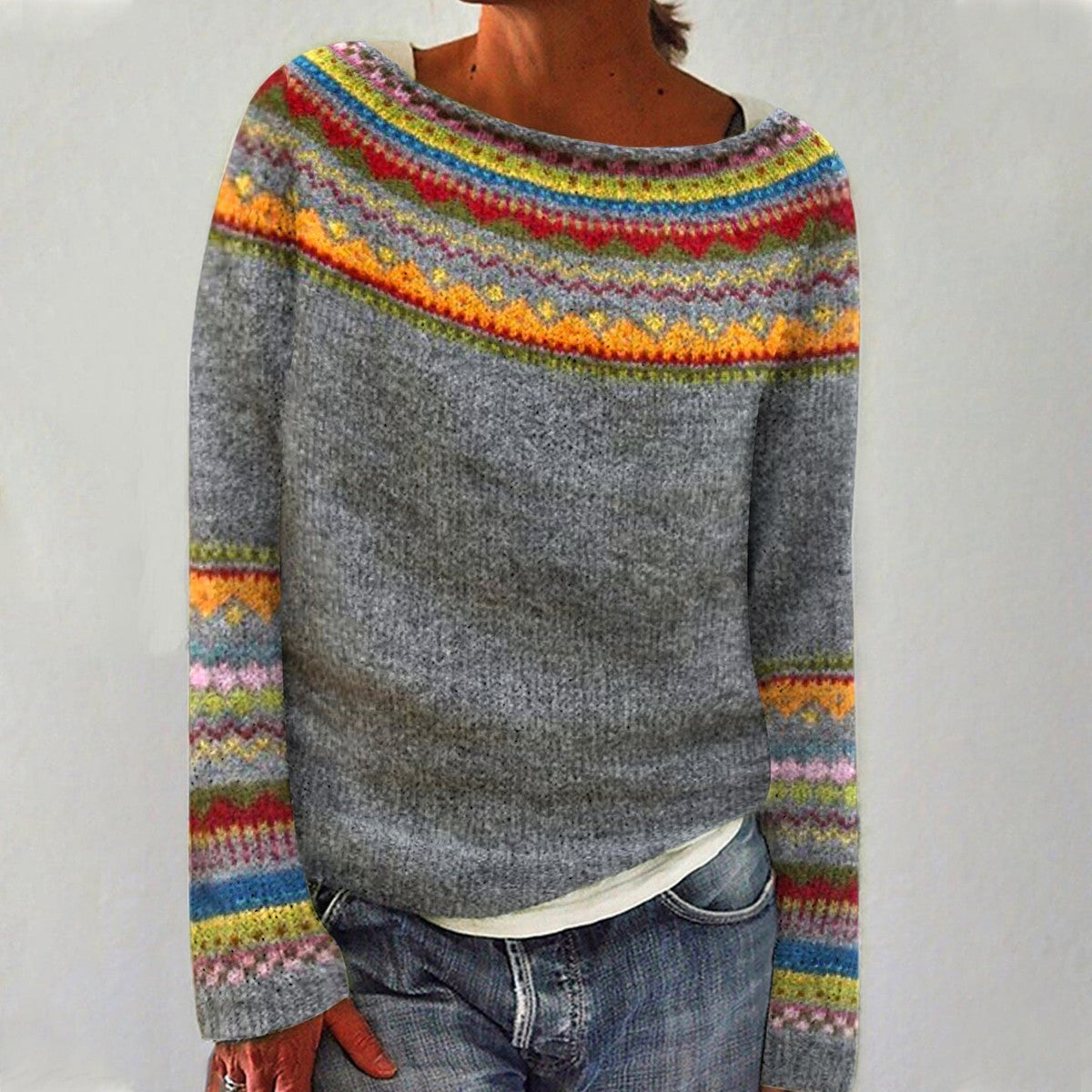 A woman wearing a retro sweater with a colourful Nordic pattern, cosy for fall.
