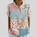 A woman wearing a patchwork-print top blending florals and polka dots, finished with a chic collar, at ease at a relaxed garden gathering.