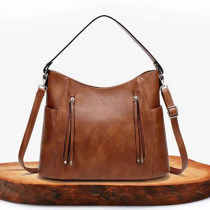 A woman carrying an elegant luxury shoulder bag with a rich finish