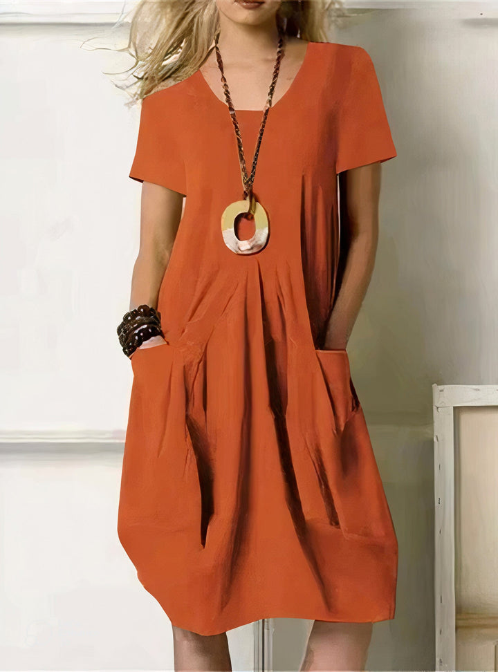 Woman wearing the Paula™ A-line midi dress with pockets and a round neckline, out on an everyday errand.