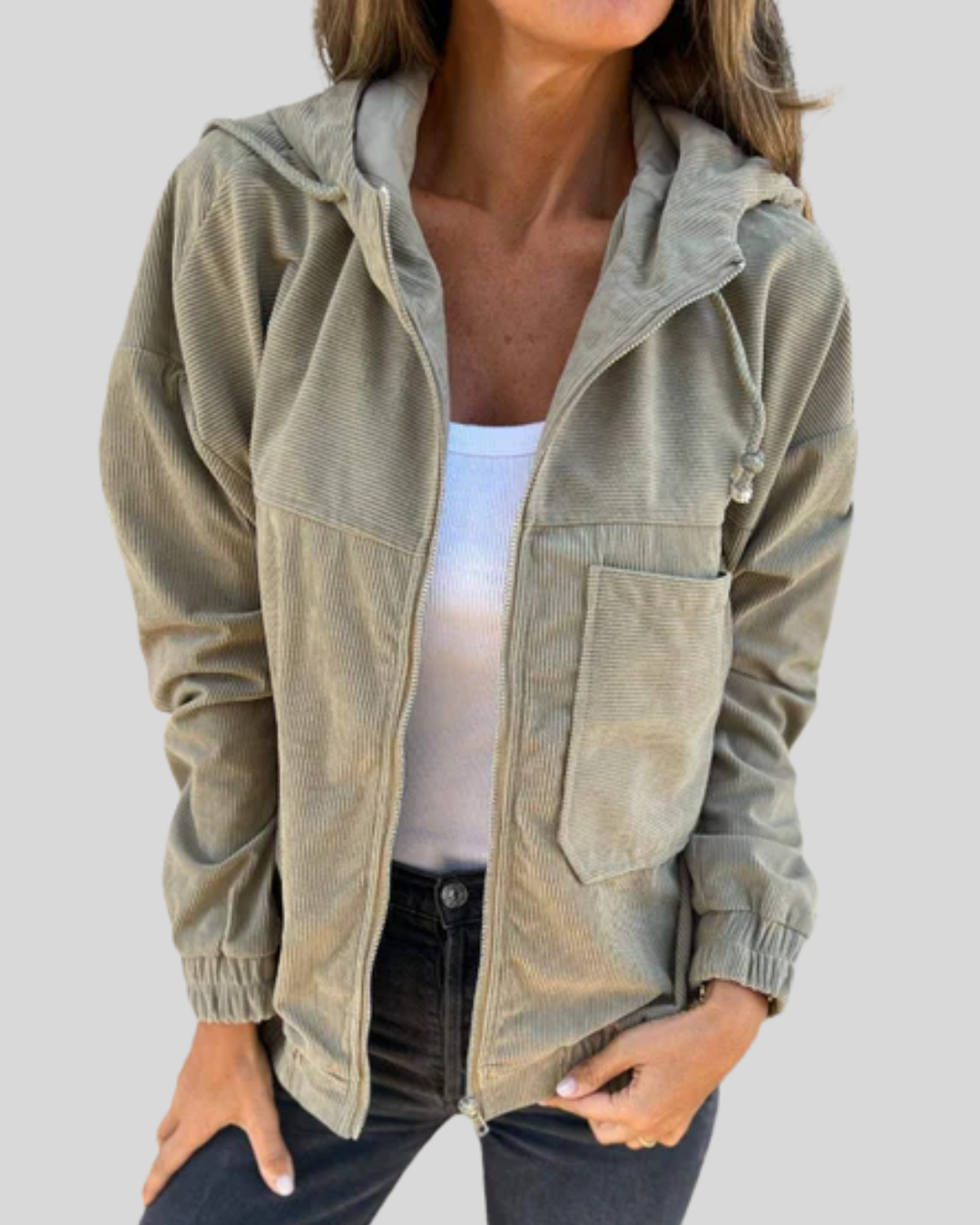 A woman wearing a blue zip-up hooded jacket with a soft ribbed texture and long sleeves.