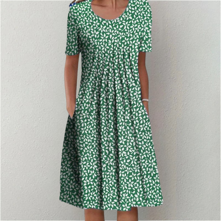 Woman wearing the floral midi dress with pockets, walking outdoors on a sunny day.