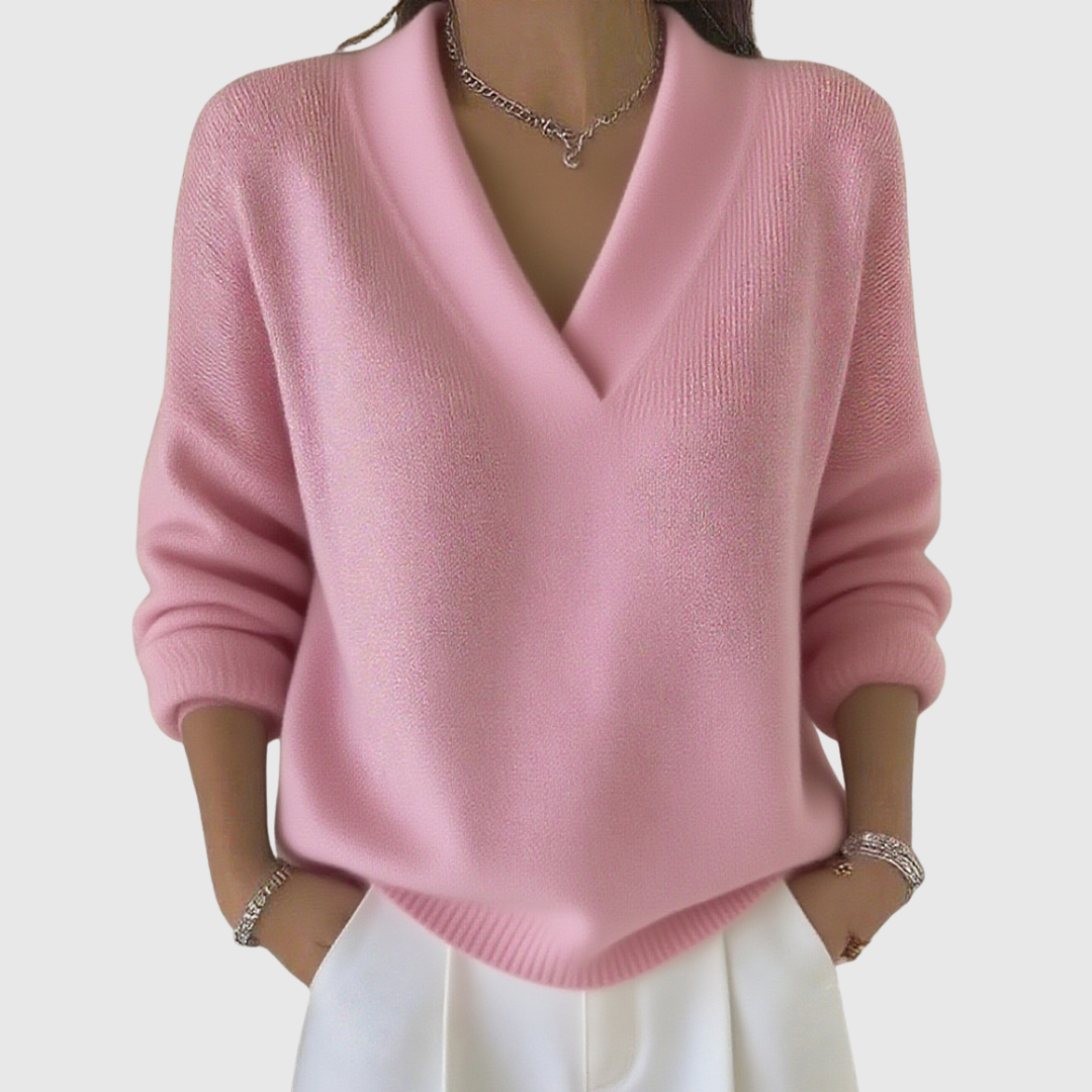A woman wearing a soft draped V-neck sweater with jeans for an effortlessly elegant look.