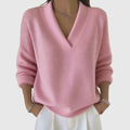 A woman wearing a soft draped V-neck sweater with jeans for an effortlessly elegant look.