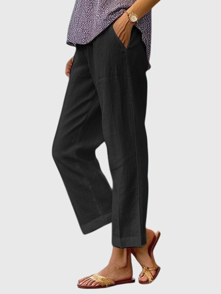A woman wearing elegant tailored pants with a flattering straight-leg cut and clean lines.