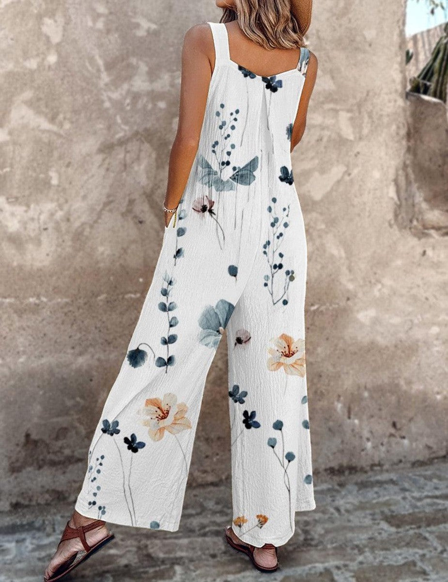 A woman wearing elegant black overalls with a single large cream bloom and adjustable straps.