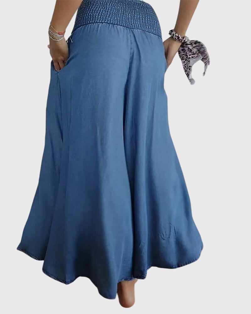 A woman in wide-leg pants with a high elastic waist, styled for a relaxed boho look.