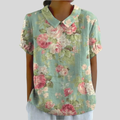 A woman wearing a floral top with a polo collar on a relaxed day