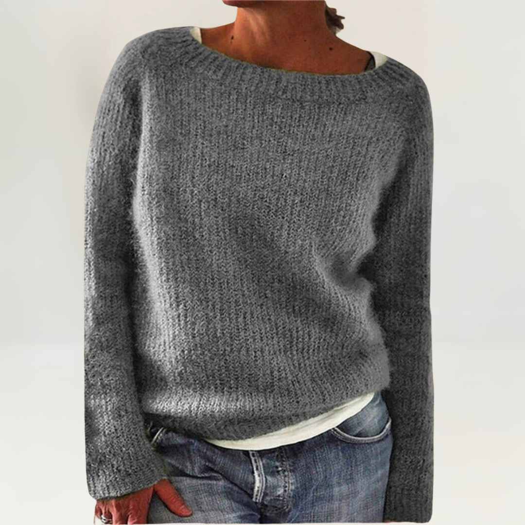 A woman wearing a soft, relaxed everyday sweater, comfortable and elegant with jeans.