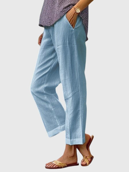 A woman wearing elegant tailored pants with a flattering straight-leg cut and clean lines.