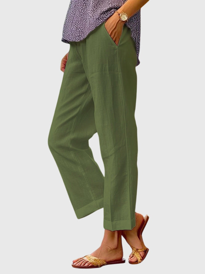 A woman wearing elegant tailored pants with a flattering straight-leg cut and clean lines.