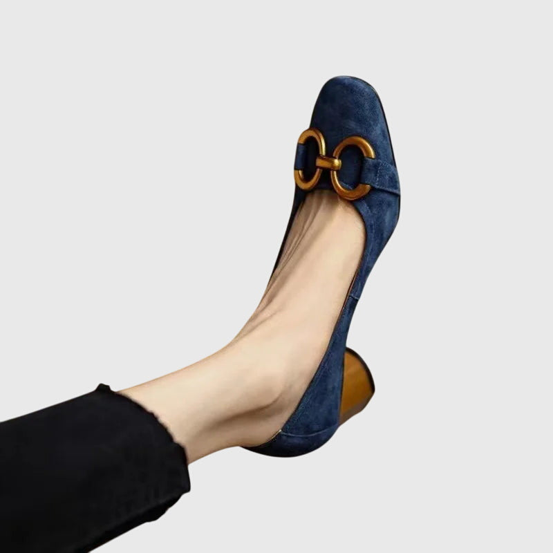A woman wearing elegant high heels with a tailored evening outfit