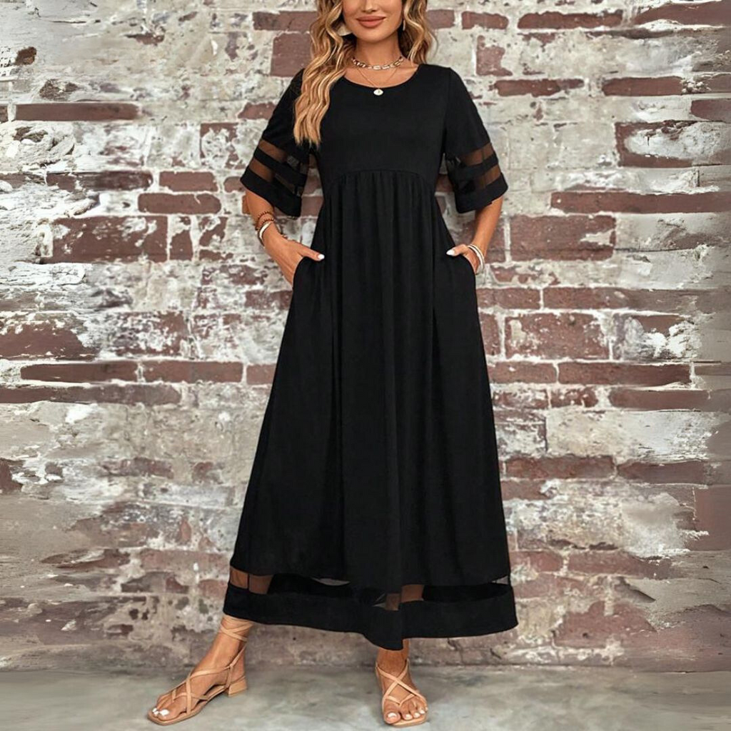 Woman wearing the Colleen™ empire waist midi dress with a flowing skirt and round neckline at a family gathering.