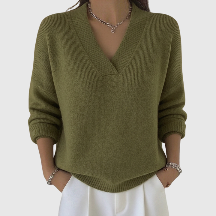 A woman wearing a soft draped V-neck sweater with jeans for an effortlessly elegant look.