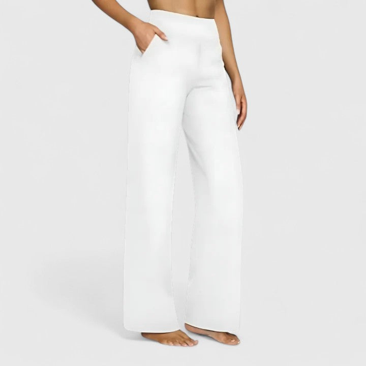 Woman wearing pull-on pants with a soft blouse, relaxed and comfortable at home.