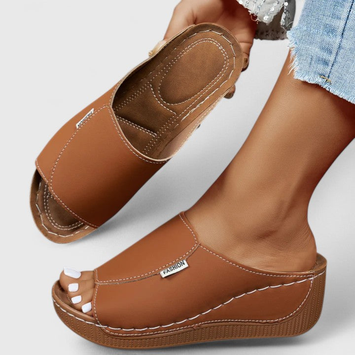 A woman in tan lightweight sandals stepping out gracefully, feet cushioned and supported.