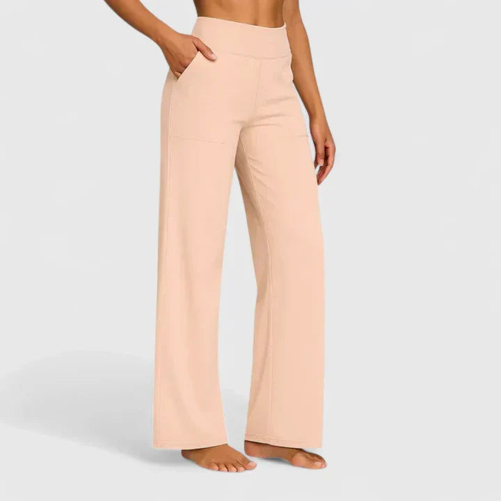 A woman in tailored pants styled with a simple top for an elegant, comfortable everyday look.