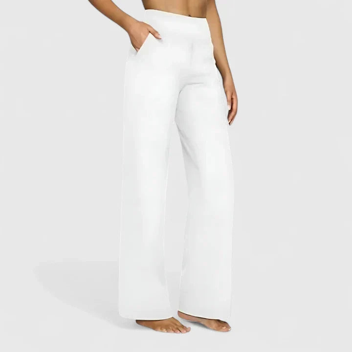 A woman in tailored pants styled with a simple top for an elegant, comfortable everyday look.