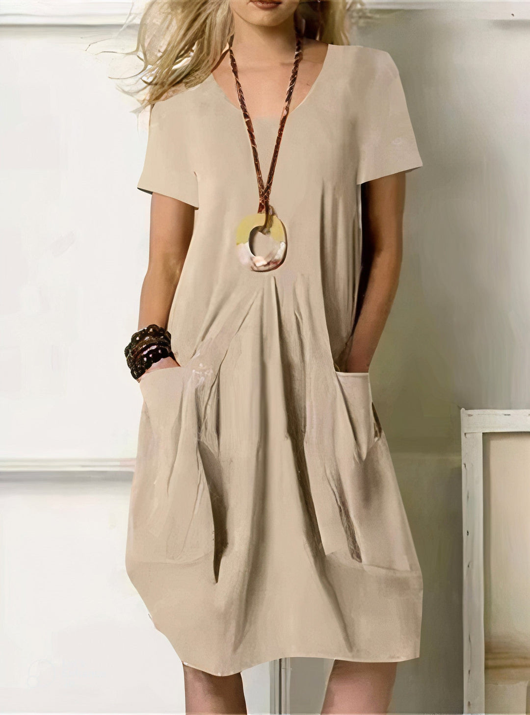 Woman wearing the Paula™ A-line midi dress with pockets and a round neckline, out on an everyday errand.