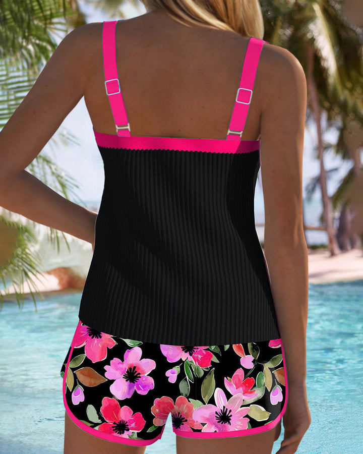 A woman at the water's edge in a bright printed two-piece tankini, relaxed and confident.