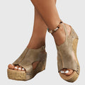 A woman in studded wedge sandals with an open front at a summer event.