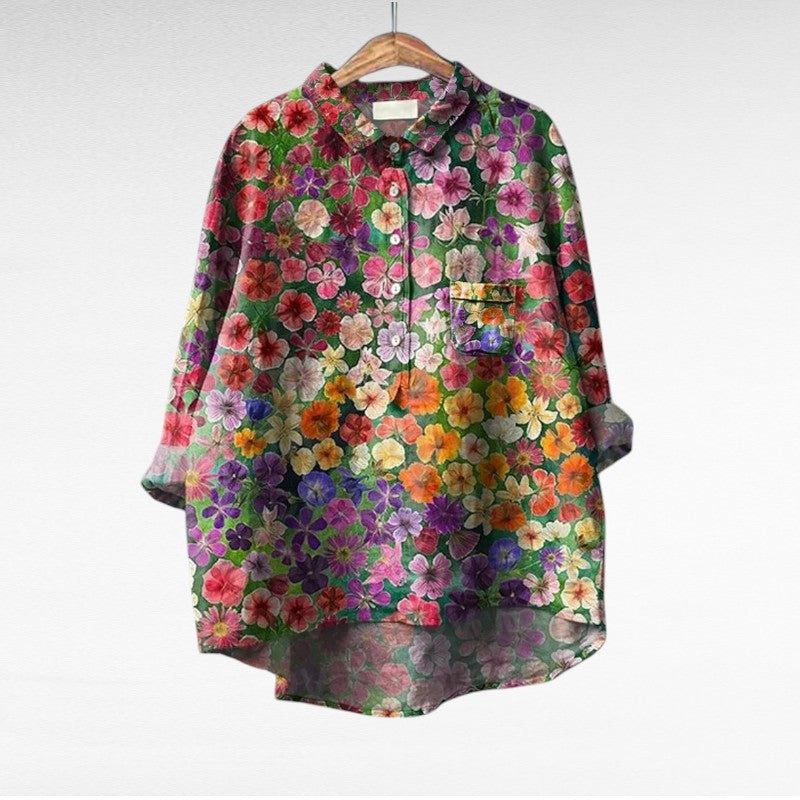 A woman wearing an elegant printed summer blouse with pants, looking cool and stylish on a warm day.