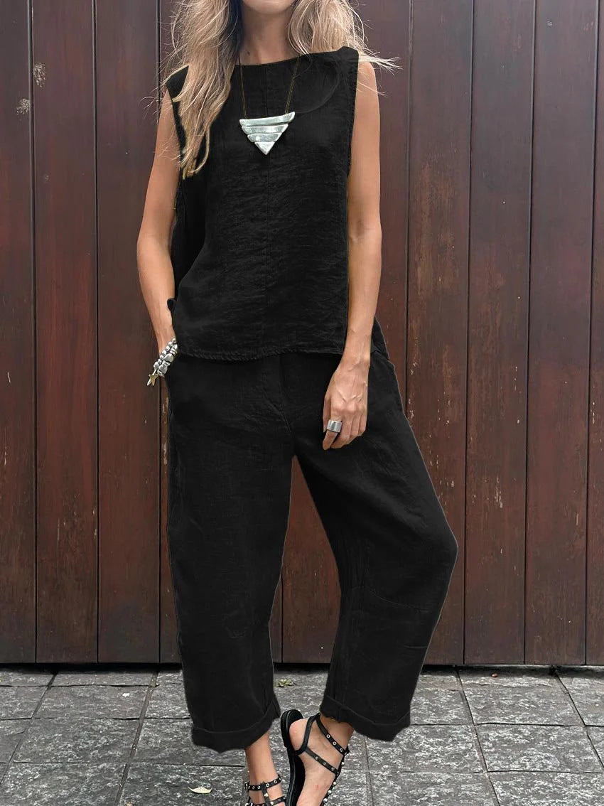 A woman wearing a relaxed sleeveless top with ankle-length pants, easy and elegant.