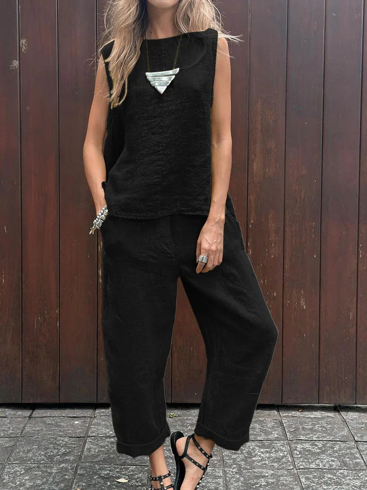 A woman wearing a relaxed sleeveless top with ankle-length pants, easy and elegant.