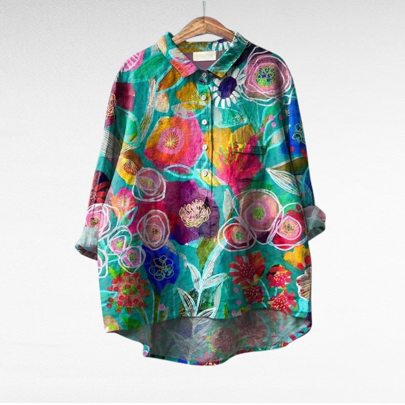 A woman wearing an elegant printed summer blouse with pants, looking cool and stylish on a warm day.