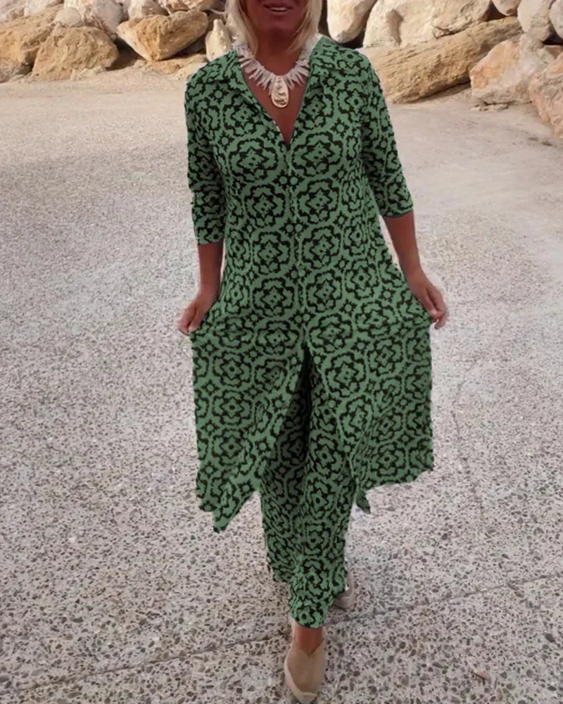 A woman wearing a black-and-white geometric-print longline top with matching pants, standing outdoors.
