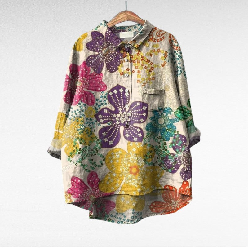 A woman wearing an elegant printed summer blouse with pants, looking cool and stylish on a warm day.
