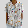 A woman wearing an everyday floral top with a polo collar, looking effortlessly elegant.