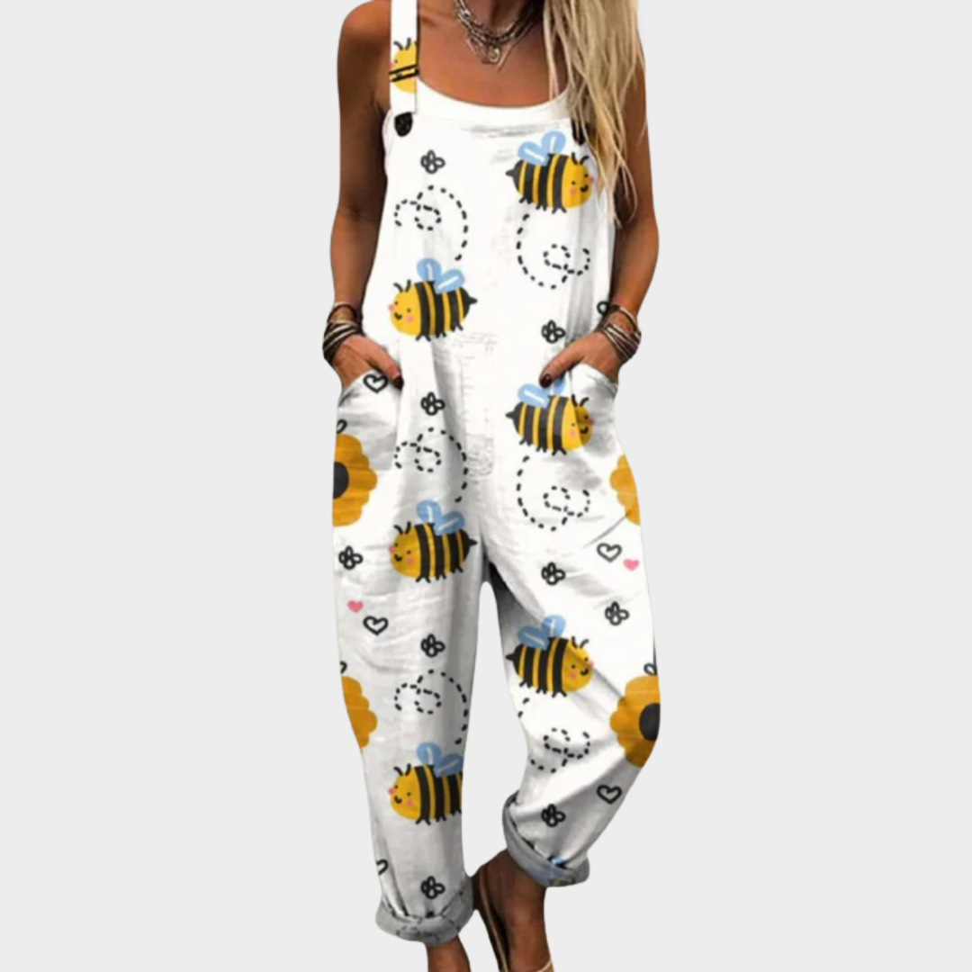 Woman wearing white overalls printed with busy yellow-and-black bees and fine flourishes