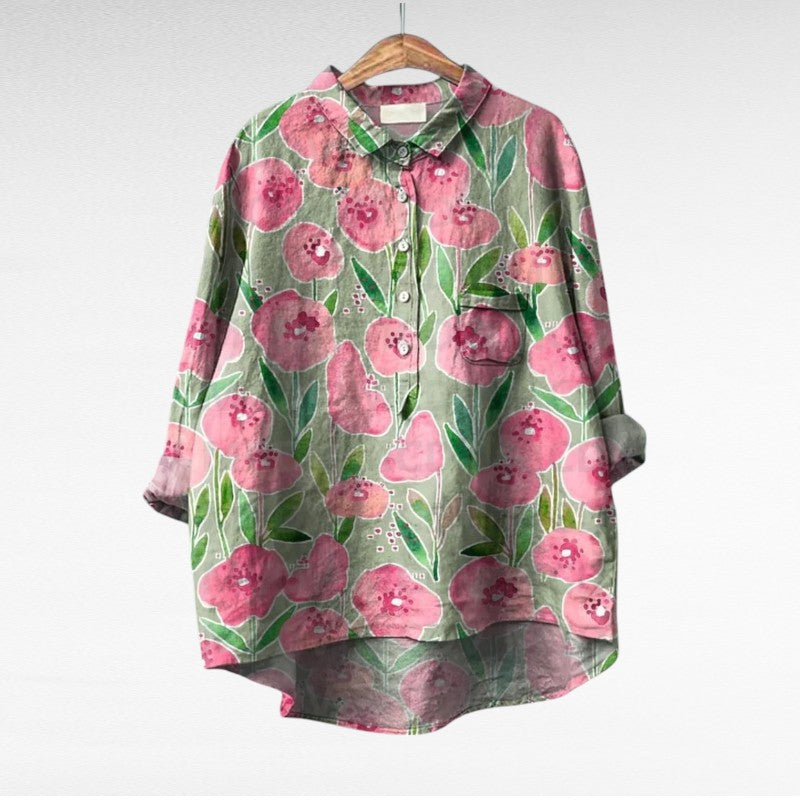 A woman wearing an elegant printed summer blouse with pants, looking cool and stylish on a warm day.
